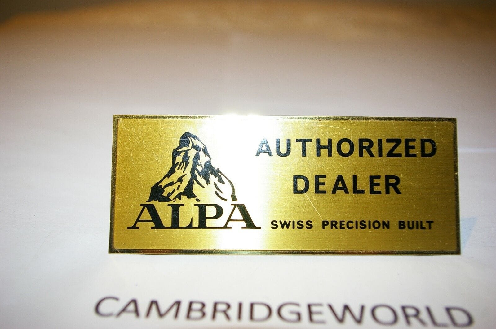 Alpa Collectibles:Advertising:Merchandise & Memorabilia:Signs:Reproduction ALPA CAMERA 41/4X13/4" inches GOLD COLOR METAL AUTHORIZED DEALER SIGN